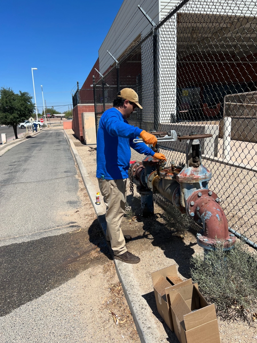 A man standing next to a fire hydrant.